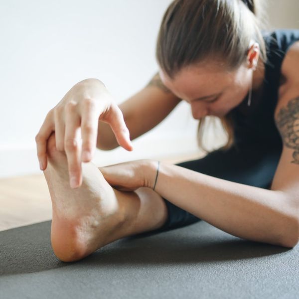 A person in a calm, focused pose on a training mat.